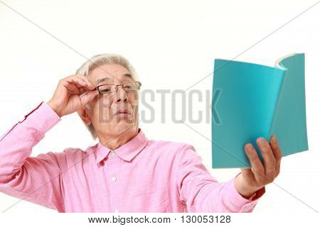 senior Japanese man with presbyopia on white background