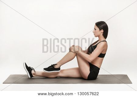 Portrait of young attractive woman doing exercises. Brunette with fit body on yoga mat. Healthy lifestyle and sports concept. Series of exercise poses.