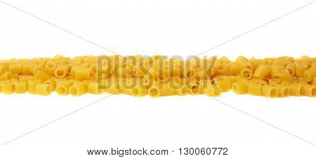 Line made of dry ditalini yellow pasta over isolated white background
