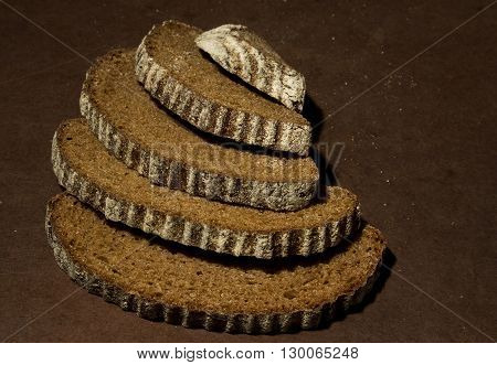 Five cut pieces of rye bread close-up