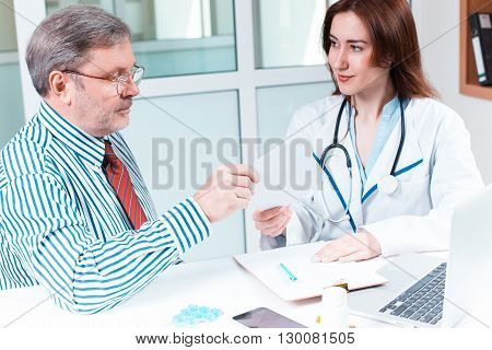 The patient and his doctor in medical office. Healthcare concept