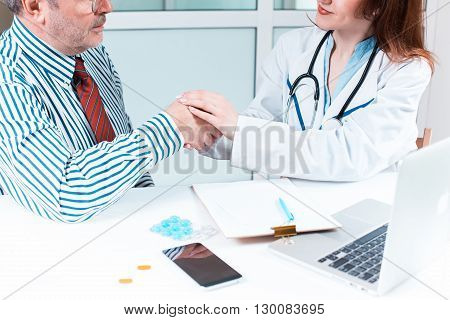 The patient and his doctor in medical office. Healthcare concept