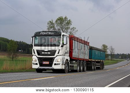 SALO, FINLAND - MAY 15, 2016: White MAN TGX 35.560 truck transports grain in South of Finland on an overcast day of spring.