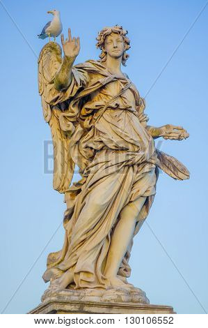 ROME, ITALY - JUNE 13, 2015: Stone sculture in Rome, female angel with wings and a big nice dress, little bird in her shoulder.