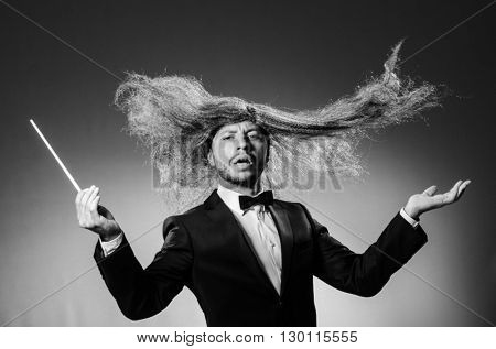 Funny conductor against dark background