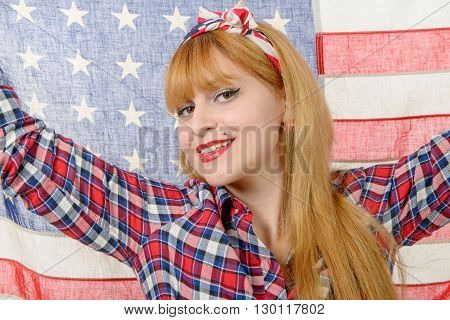 a sexy pin up girl holding an American flag.