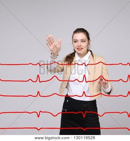 Doctor woman working with cardiogram lines