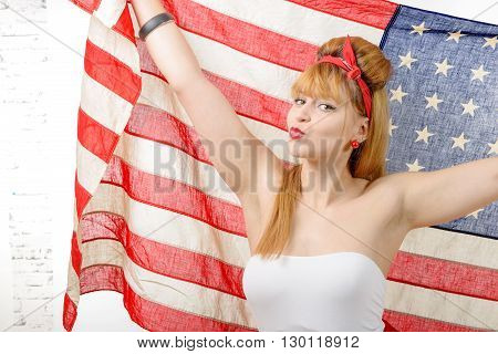 a sexy pin up girl holding an American flag.