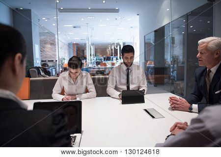 business people group brainstorming on meeting and businessman presenting ideas and projects oon laptop and tablet computer