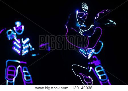 Dancers Crew In Led Suits On Dark Background, Colored Show