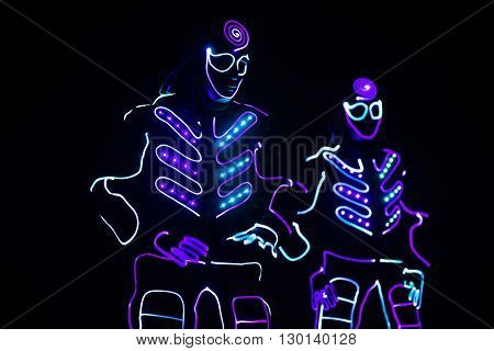 Dancers Crew In Led Suits On Dark Background, Colored Show