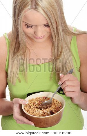 Young corpulent woman eating muslin, isolated on white