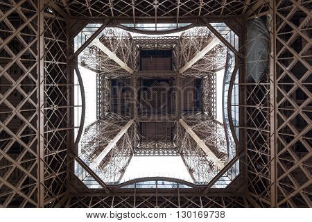 Symmetric view on the bottom part of the Eiffel Tower was taken under the tower