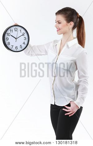 Smiling Business woman holding in hands clock isolated on white background