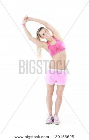 Portrait of young woman doing stretching exercise