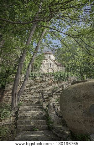 Landscape with ancient monastery in the woods.