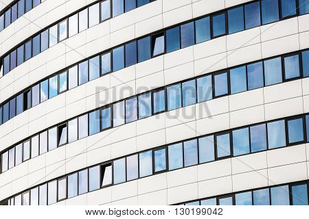 Facade of a modern office building. Modern industrial building made of glass and steel.