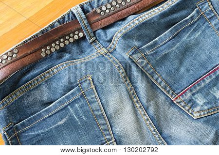 blue jeans with brown leather belt, clothing industry