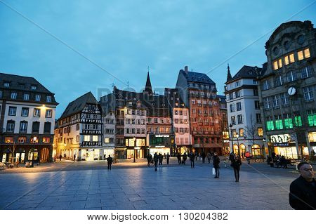 STRASBOURG FRANCE - MAR 24 2016: Place Kleber UNESCO World Heritage site in central Strasbourg with tourist admiring the city at the evening