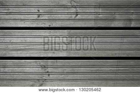 Three gray wooden planks of the pier