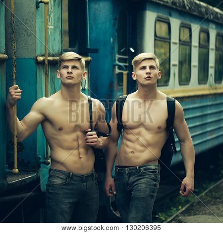Muscular Guys Near Railway Train