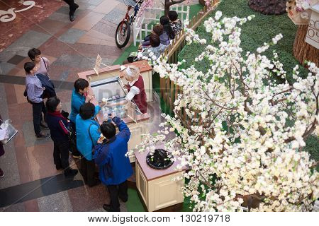 MOSCOW - APRIL 13: People buy ice cream in GUM store on April 13 2016 in Moscow. GUM is the large store in the Kitai-gorod part of Moscow facing Red Square.