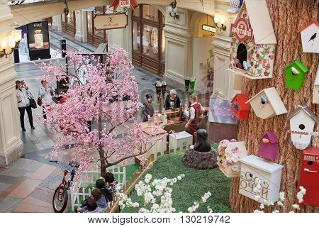 MOSCOW - APRIL 13: The interior decorated artificial tree and birdhouses in GUM store on April 13 2016 in Moscow. GUM is the large store in the Kitai-gorod part of Moscow facing Red Square.
