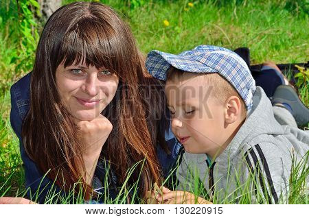 Woman And Child Playing On Green Grass