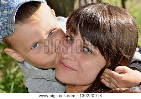 Little Boy Hugging And Kissing His Mother, Close-up