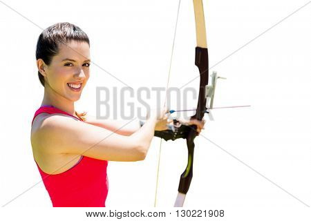 Portrait of sportswoman is smiling and practising archery