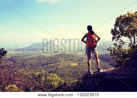 successful woman hiker enjoy the view on mountain top