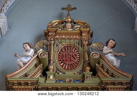 ZAGREB, CROATIA - SEPTEMBER 14: IHS sign on the altar in the Basilica of the Sacred Heart of Jesus in Zagreb, Croatia on September 14, 2015