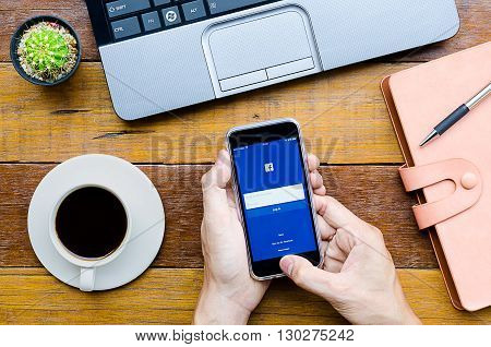 CHIANG MAITHAILAND - FEB 072016 : Man holding a iPhone 6s with Facebook application.Facebook is largest and most popular social networking site in the world.