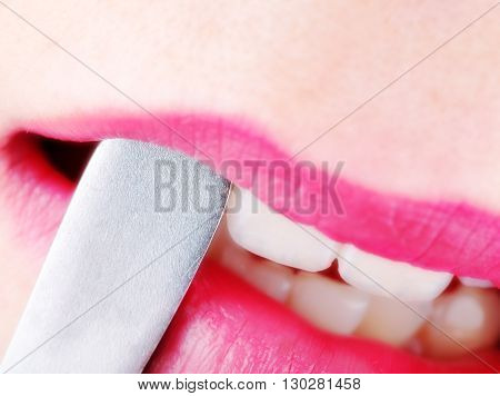 Female lips with medical tool. Close- up photo