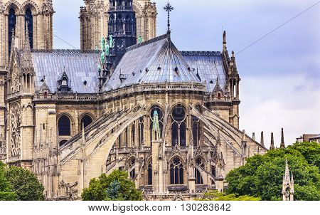 Flying Butresses Spires Towers Overcast Skies Notre Dame Cathedral Paris France. Notre Dame was built between 1163 and 1250 AD. Black Spire erected in the 1850s.
