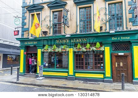 DUBLIN IRELAND - 05 MAY 2016: Tourists walking in the Temple Bar area. The place is the cultural quarter in the center of the city and is full of restaurants bars and nightclubs.