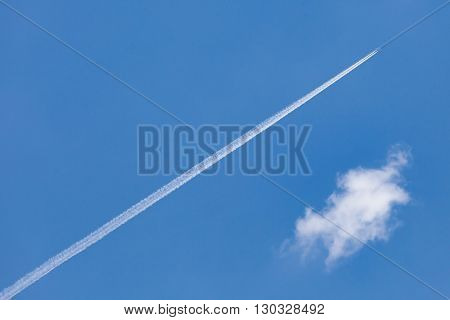 The airplane trail speed through cleared blue sky.