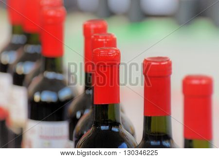 bottles of wine sealed with red tubes