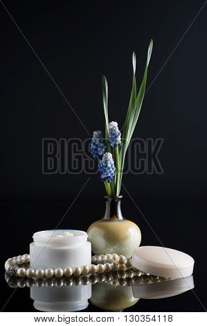 cosmetic cream floral composition muskari black background