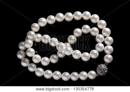 pearl necklace silver inlay clasp black background