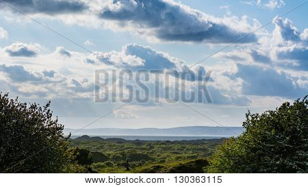 Dunes of Kenfig National Nature Reserve in Wales, UK. Landscape of sand dunes under a cloudy sky on the Welsh south coast