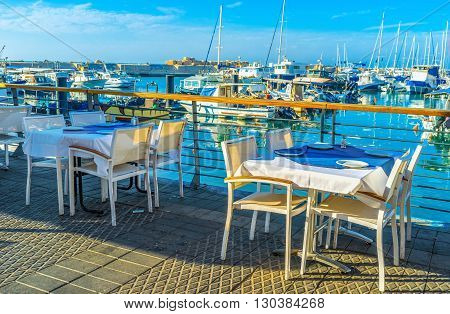 The white tables of the fish tavern in the old port of Jaffa Tel Aviv Israel.