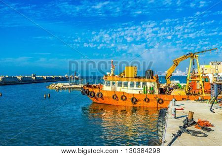 The old fishing trawler moored in industrial port of Jaffa Tel Aviv Israel.