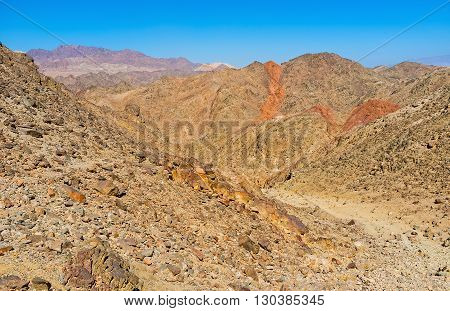 The narrow path among the steep rocky slopes leads to Zefahot Mount Eilat Israel.