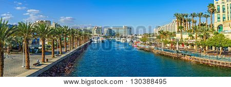 EILAT ISRAEL - FEBRUARY 23 2016: The entrance to marina surrounded by promenades with palms cafes restaurants and shopping centers on February 23 in Eilat.
