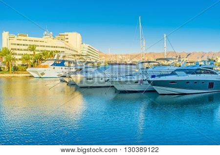 The central marina is full of luxury yachts sailing ships and small fishing boats Eilat Israel.