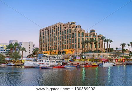 EILAT ISRAEL - FEBRUARY 23 2016: The nice view from marina promenade on the moored boats and the luxury hotel on February 23 in Eilat.