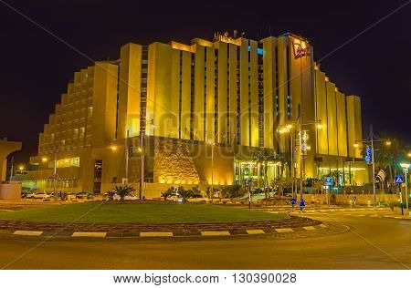 EILAT ISRAEL - FEBRUARY 24 2016: The night walk in the tourist district with brightly illuminated luxury hotels cozy gardens and quiet streets on February 24 in Eilat.