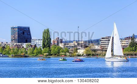 Zug, Switzerland - May 6, 2016: view on the city of Zug from Lake Zug. The city of Zug is the capital of the Swiss canton of Zug. Lake Zug (German: Zugersee) is a lake in central Switzerland situated between Lake Lucerne and Lake Zurich.