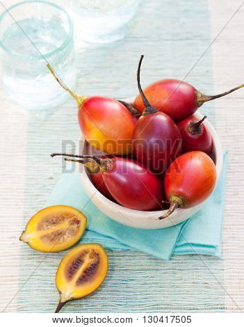 Tamarillo fruits with slice on blue napkin Outdoor background